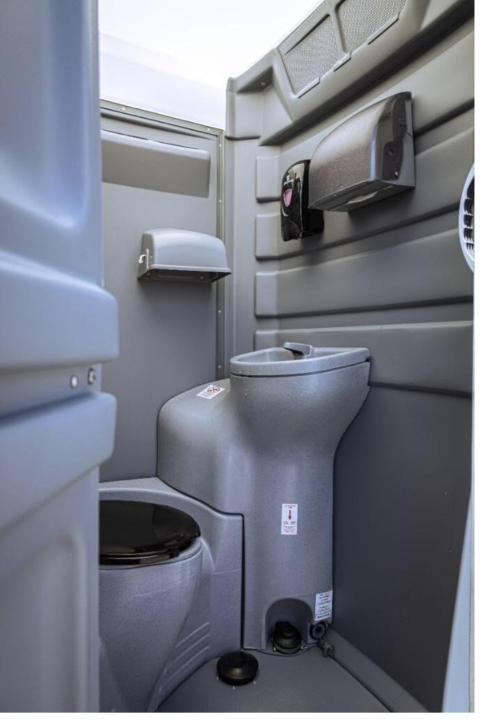 Close-up of ADA-compliant interior hardware inside a portable toilet
